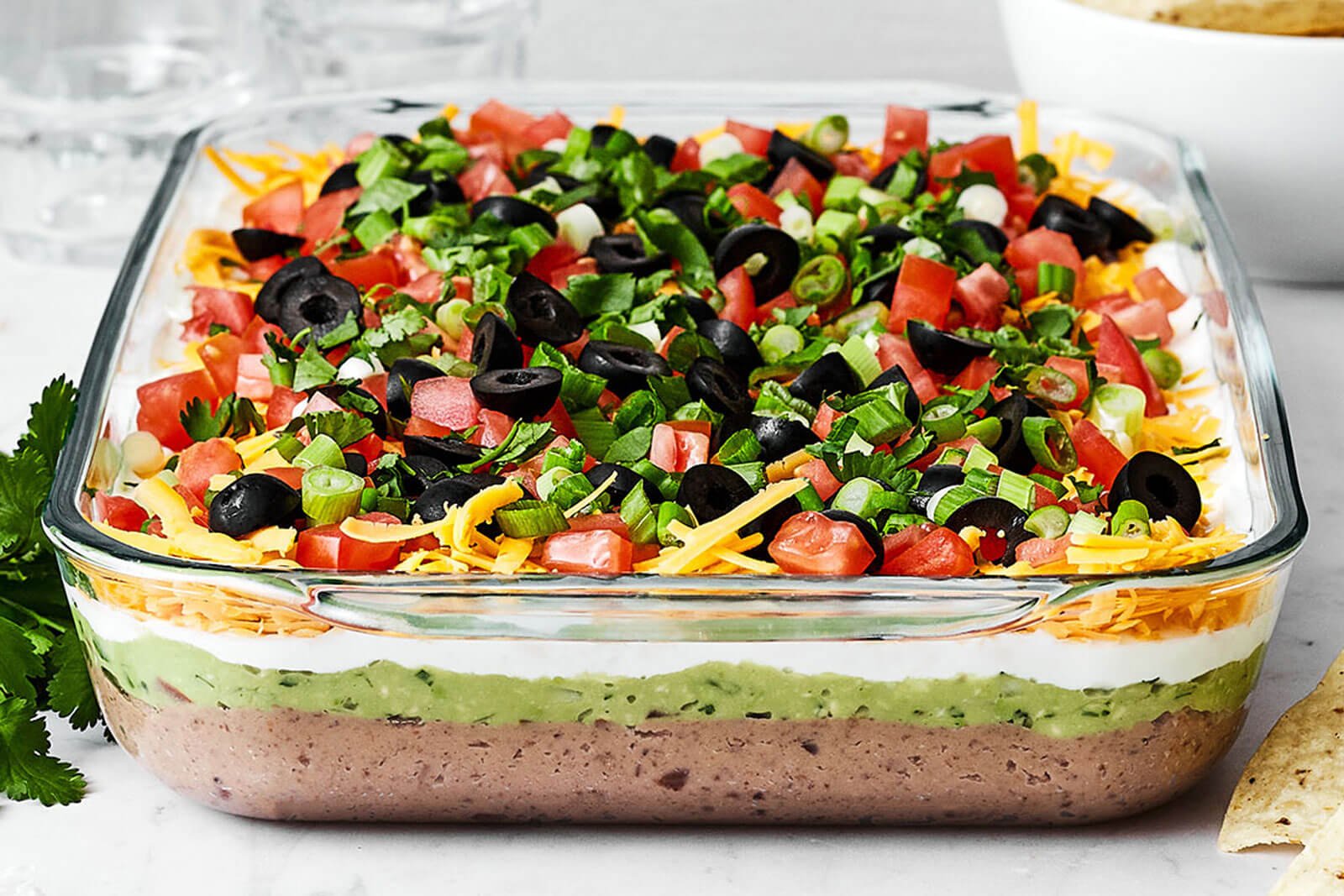 7 layer dip next to cilantro