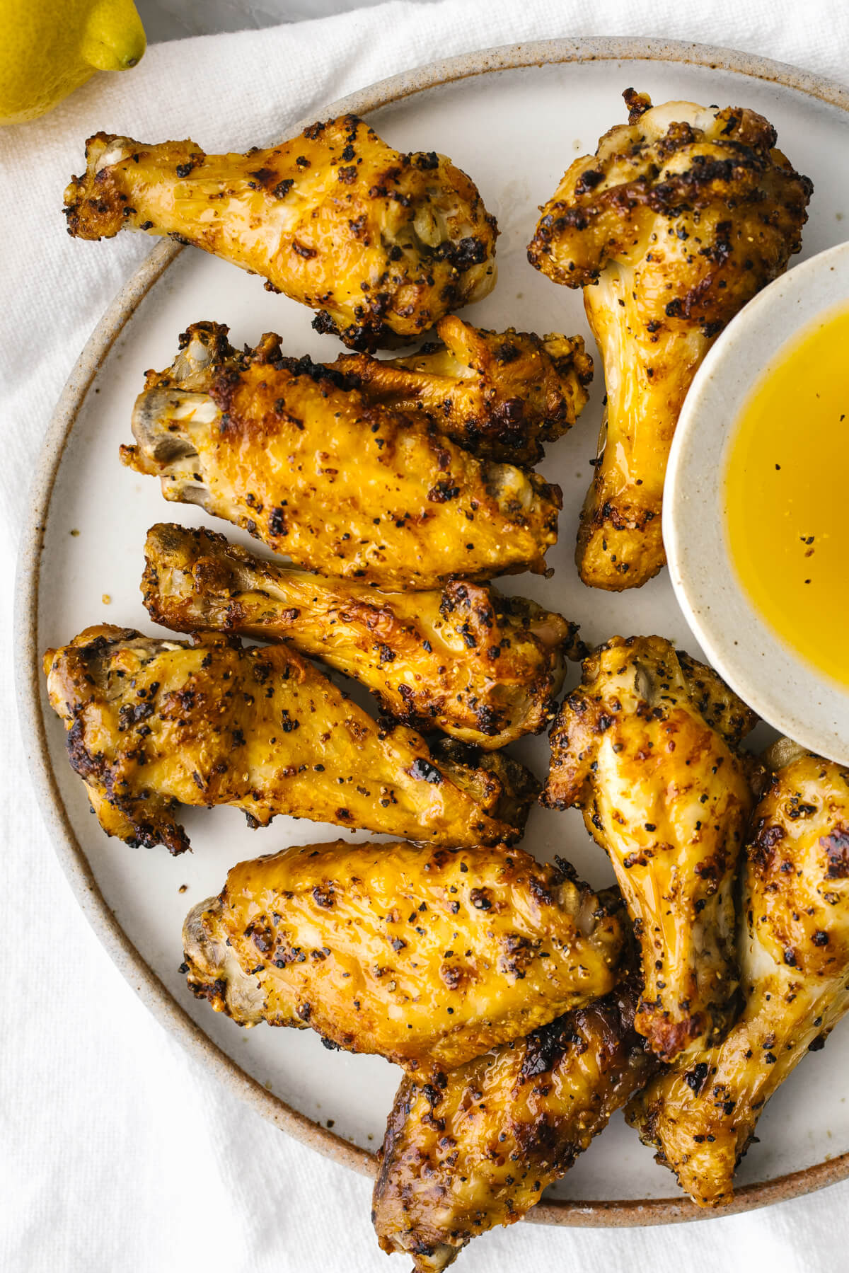 Lemon pepper air fryer chicken wings on a plate.