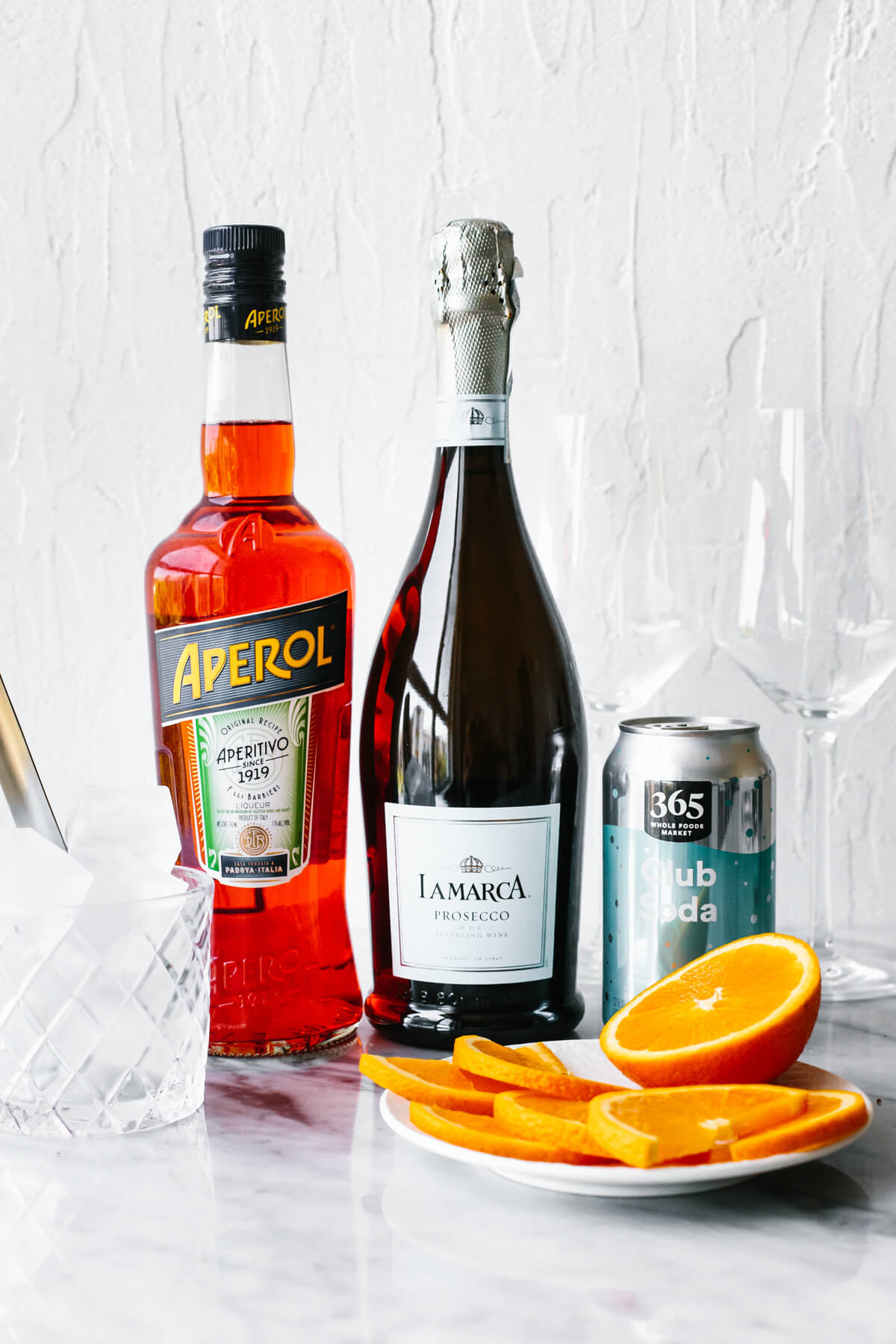 Ingredients for Aperol Spritz on a table