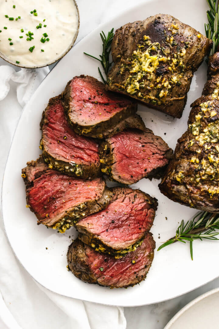 Slices of beef tenderloin on a plate.