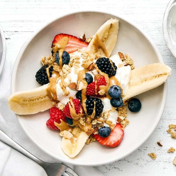 Breakfast banana split on a plate.