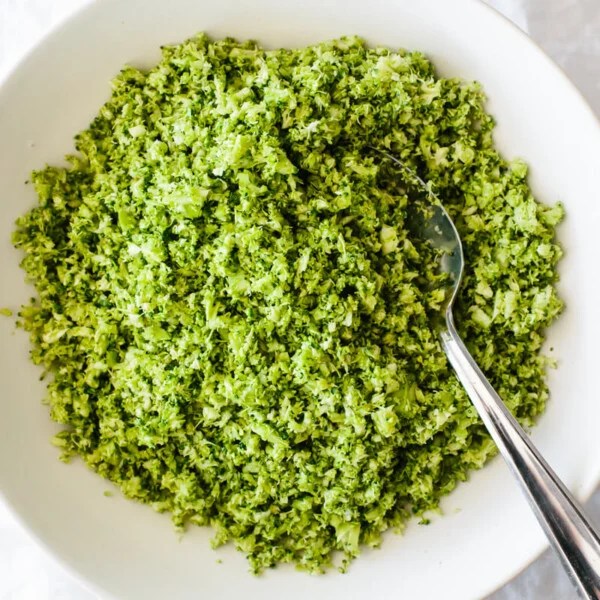 Broccoli rice in a serving bowl on a table.