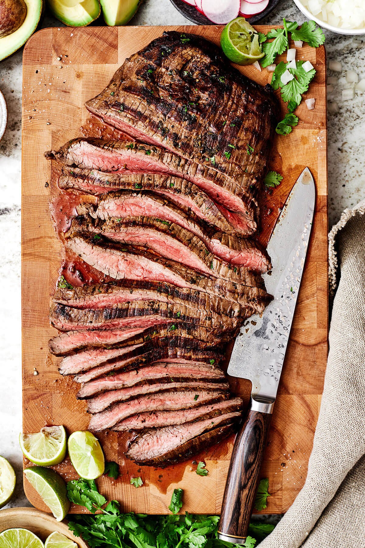 Sliced carne asada on a cutting board