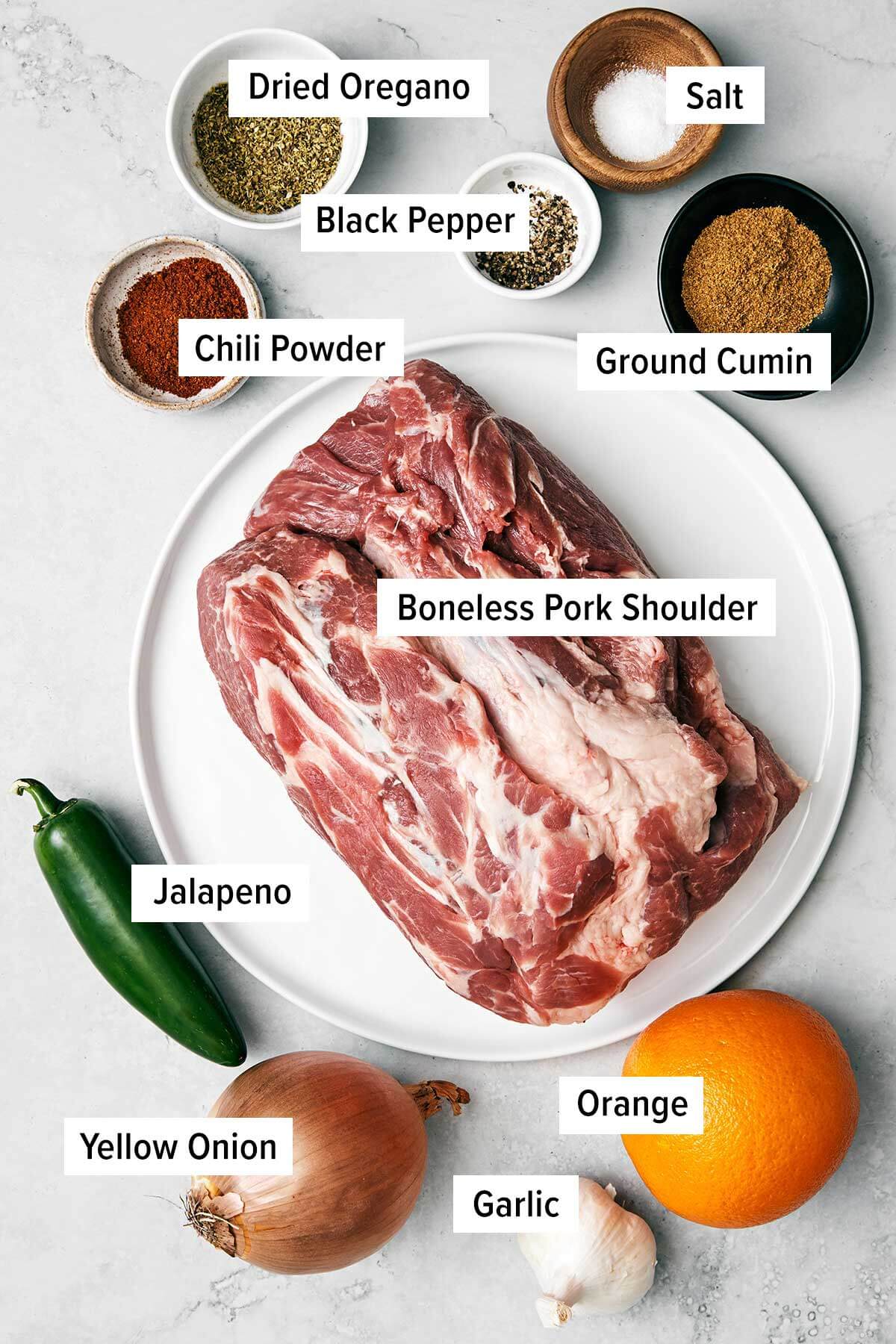 Ingredients for carnitas on a table.