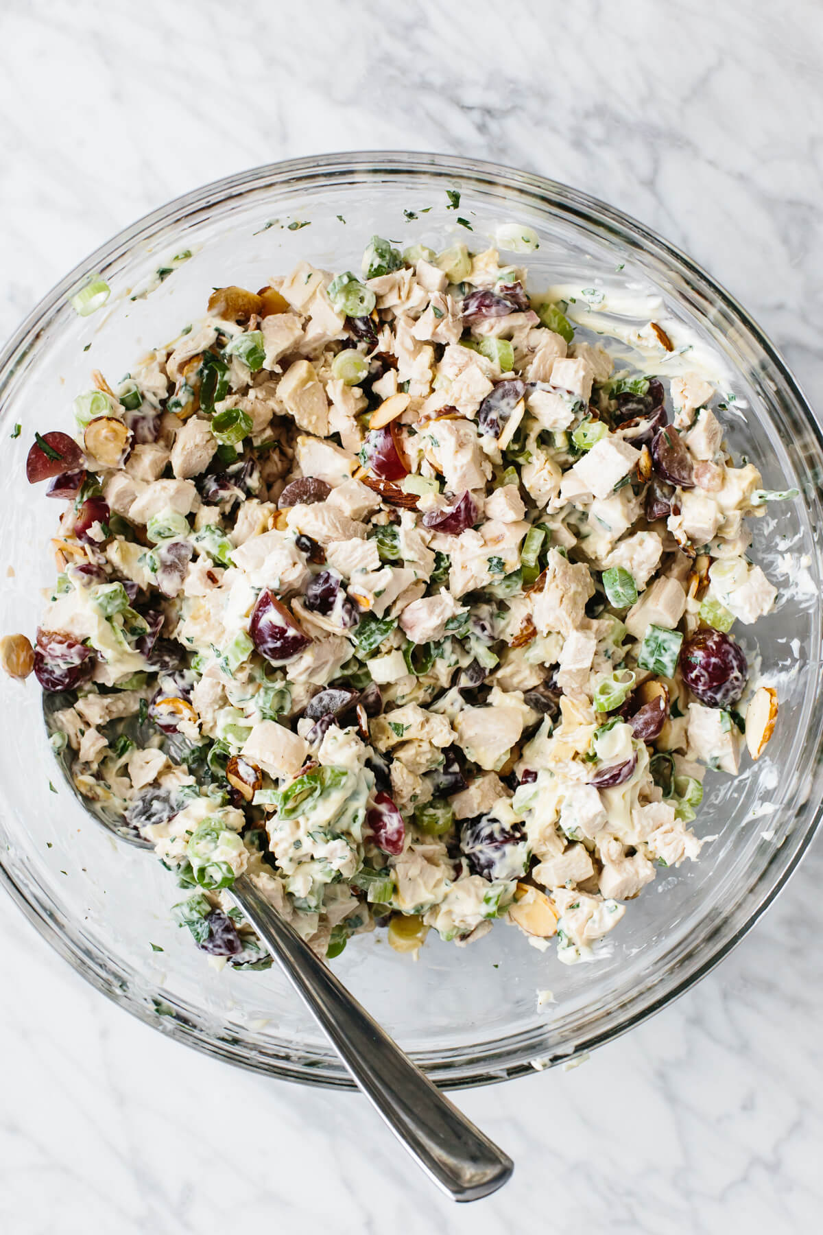 Mixing the ingredients for chicken salad in a bowl.