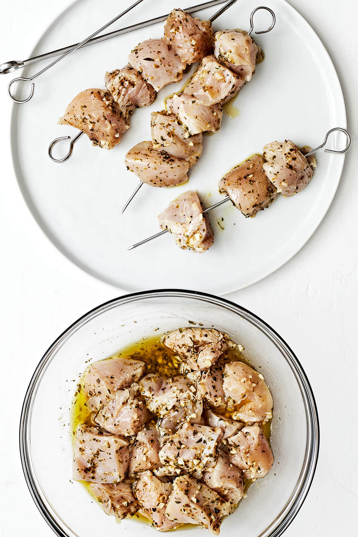 Threading chicken souvlaki on skewers