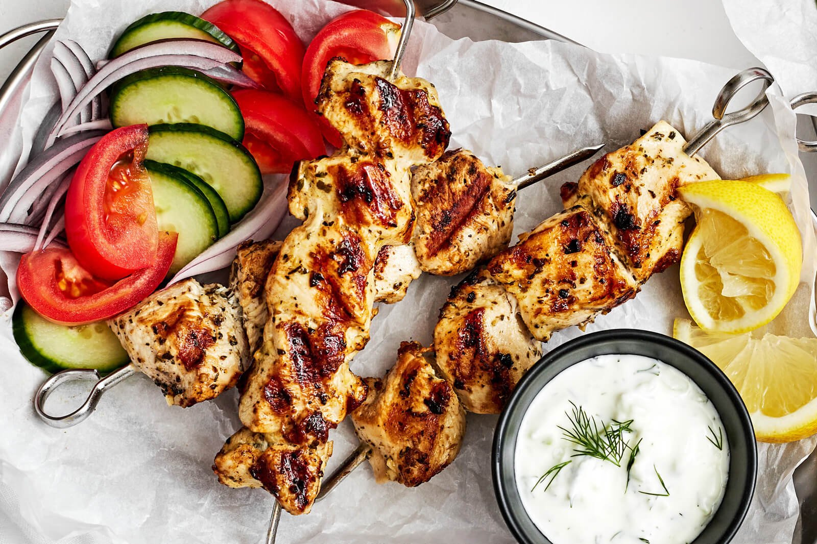 Chicken souvlaki with veggies on a plate