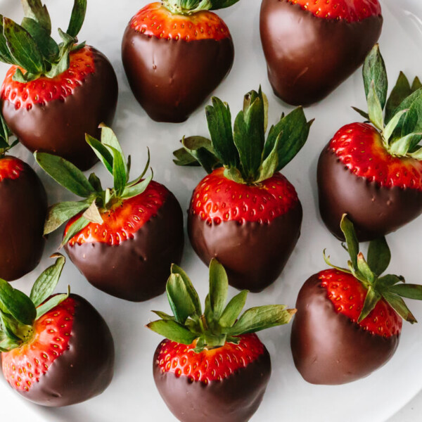 Chocolate covered strawberries on a plate.