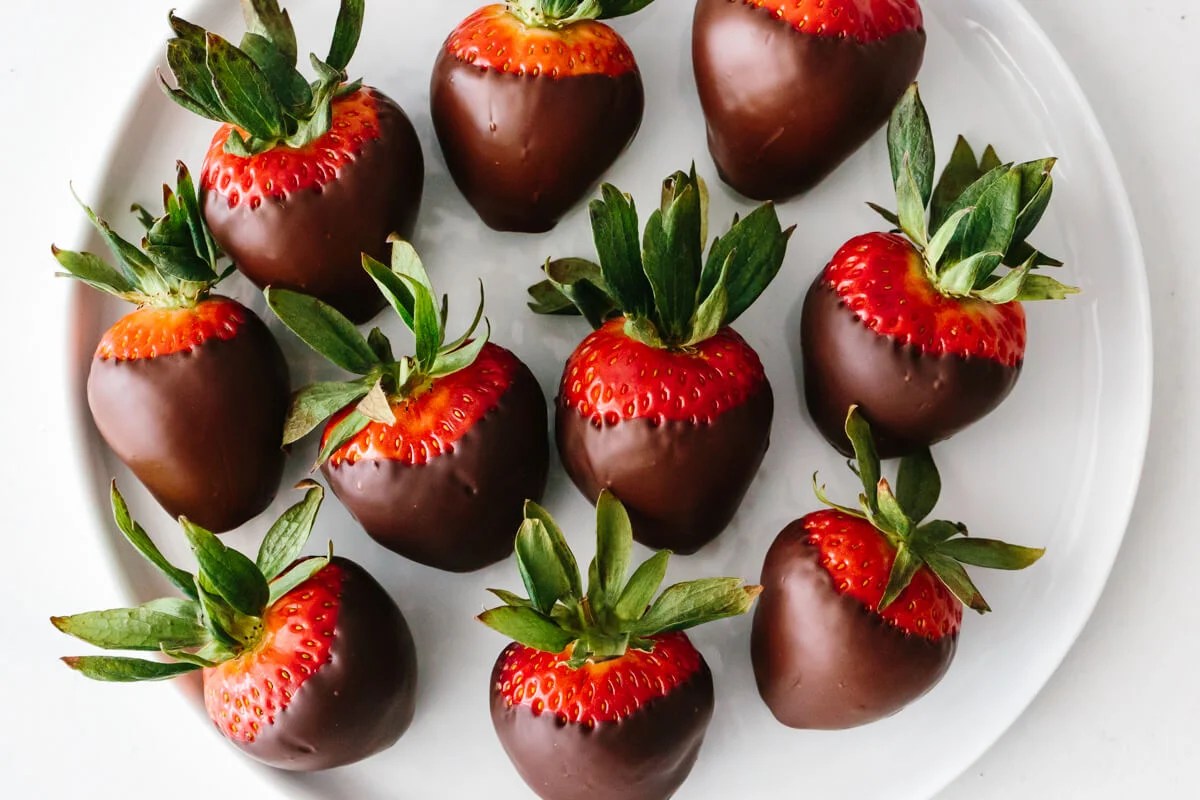 Chocolate covered strawberries on a plate.