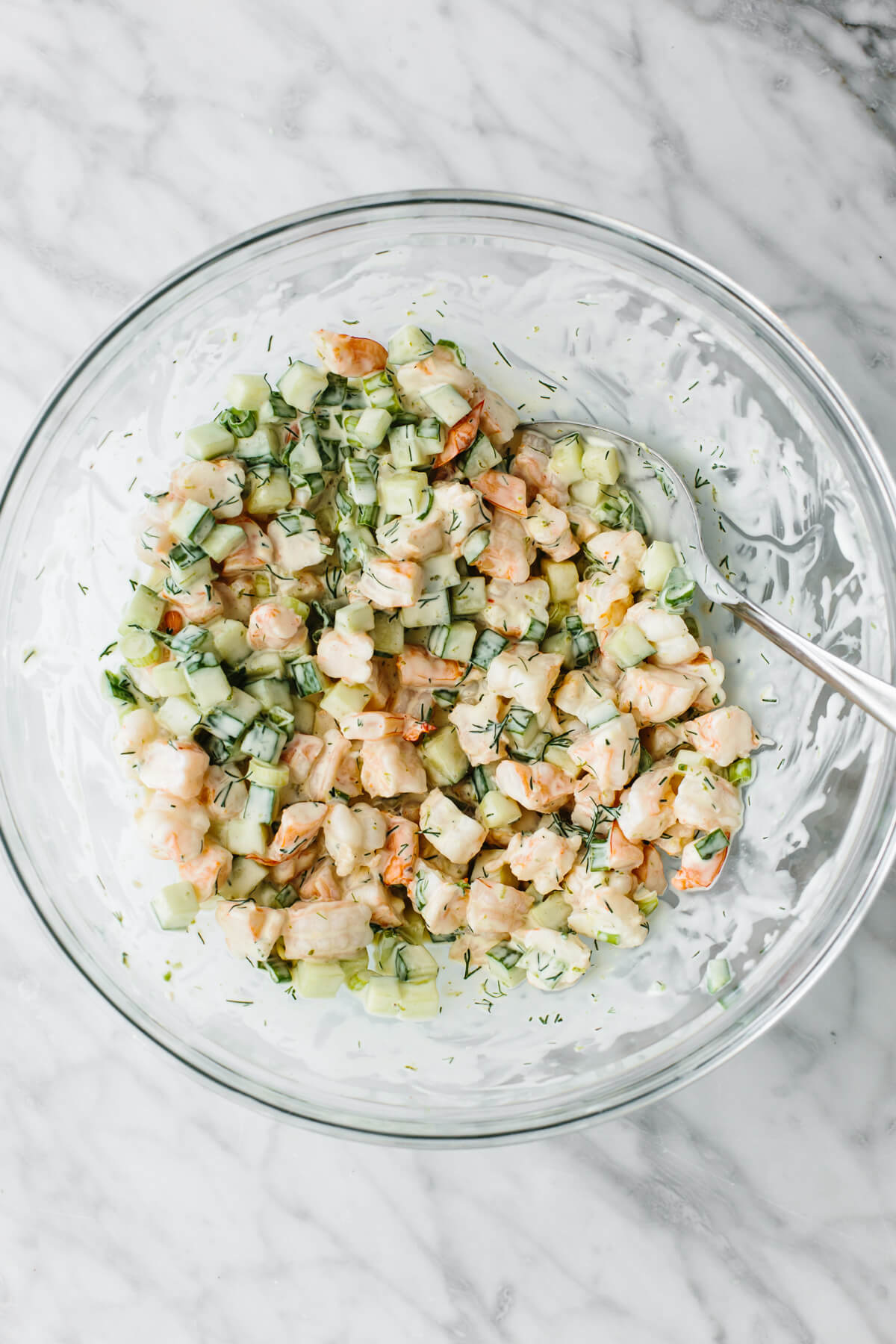 Mixed cucumber shrimp salad in a glass bowl