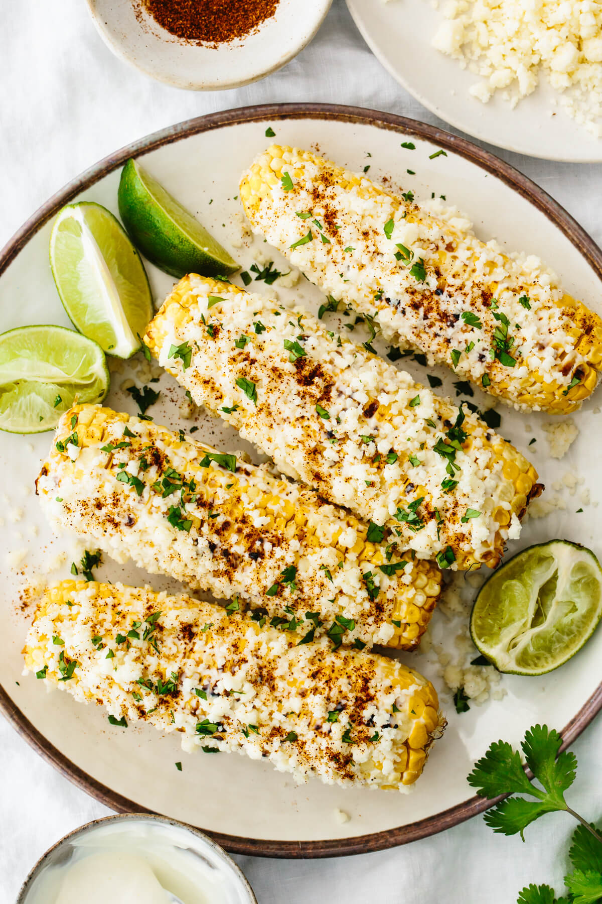 Elote on a plate with limes