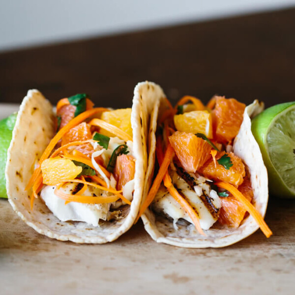 Two fish tacos on a table.