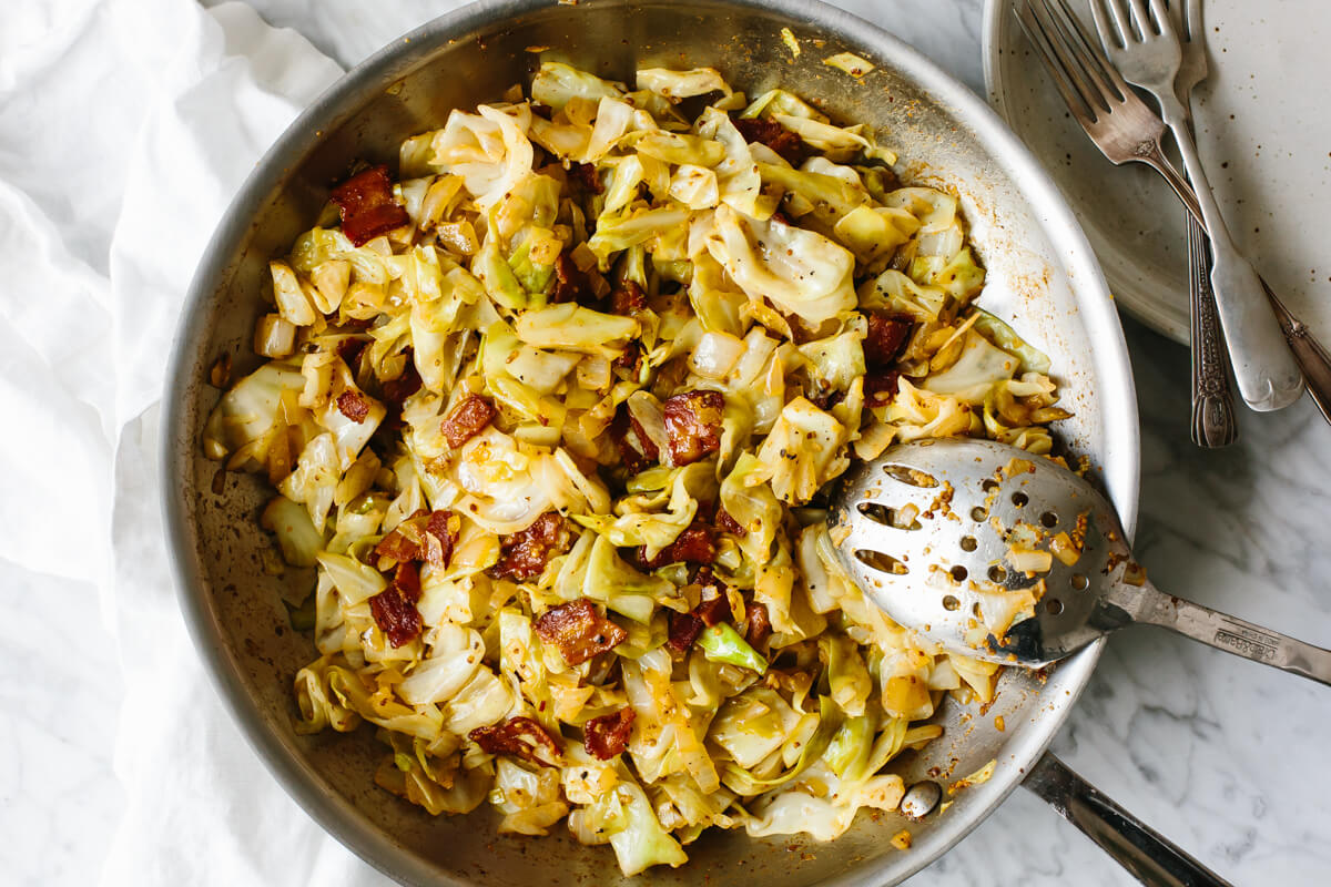 Fried cabbage in a stainless steel pan.