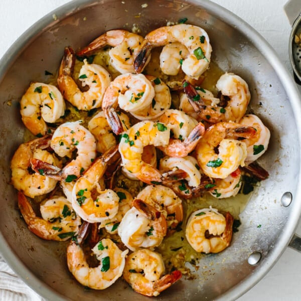 Shrimp sauteed in a pan with garlic and butter.