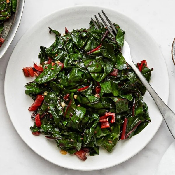 Sauteed Swiss chard on a white plate.