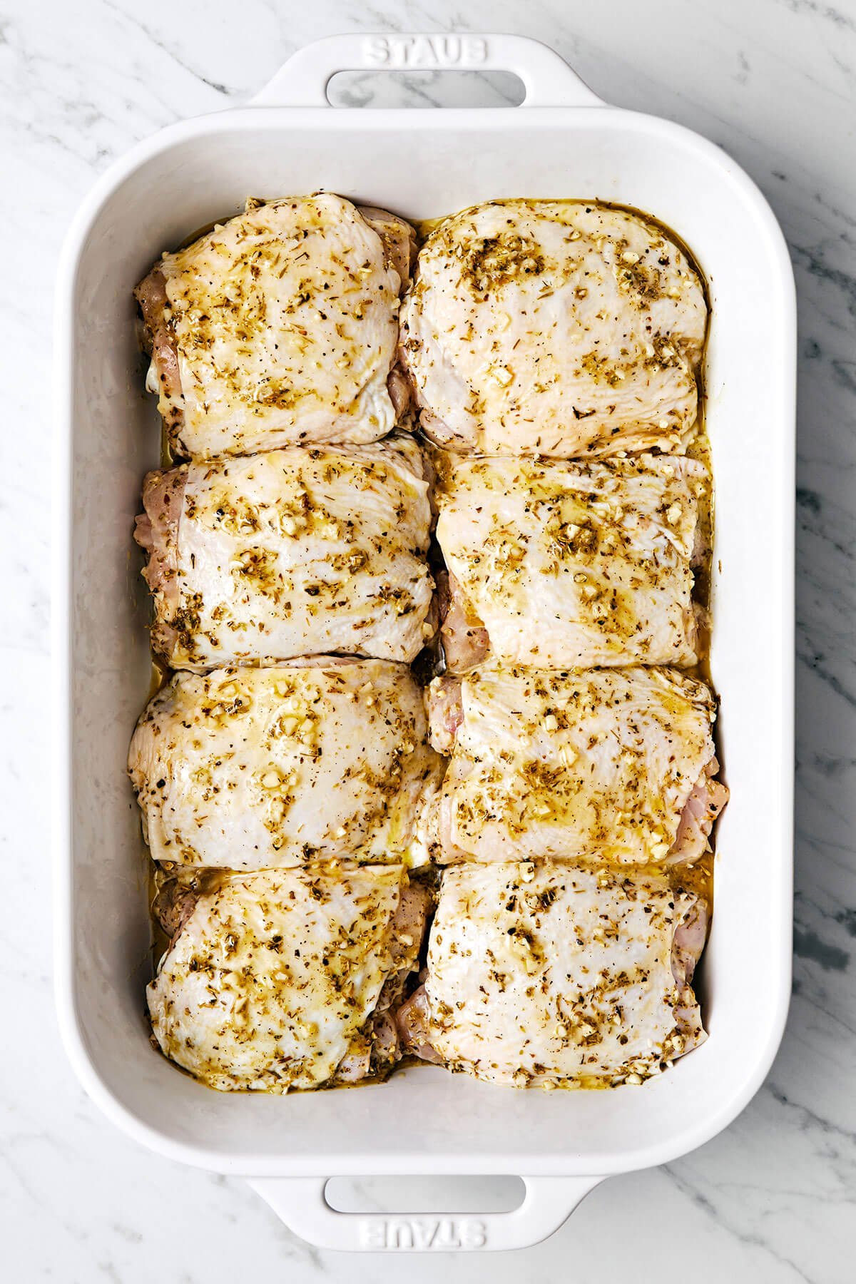 Greek lemon chicken in a white baking dish