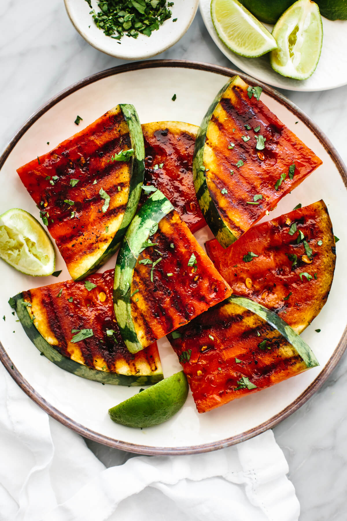 Grilled watermelon pieces on a white plate