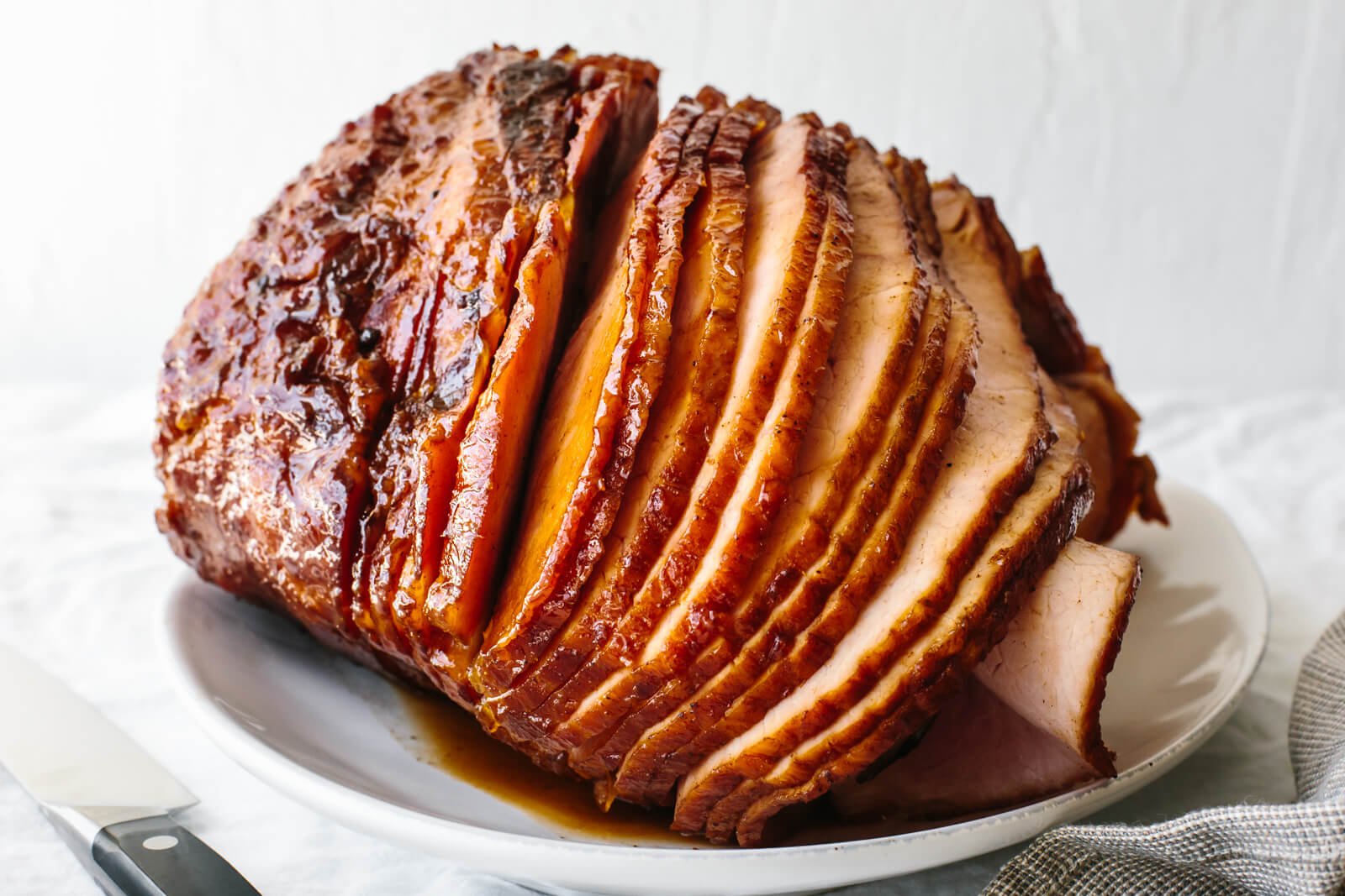 Sliced honey baked ham on a white plate