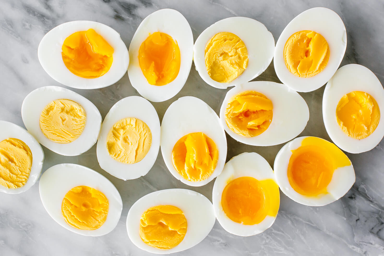 Hard boiled and soft boiled eggs on a counter