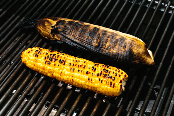 Grilling corn on the cobs on an outdoor grill