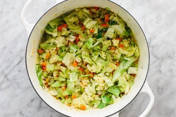 A pot cooking up cabbage soup.