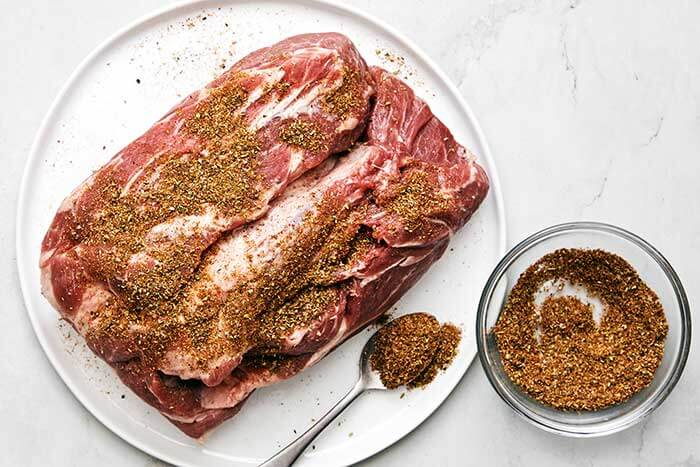 Seasoning on a pork shoulder.