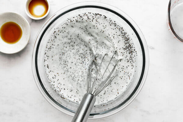 Making chia pudding in a bowl with a whisk