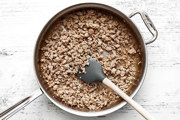 Cooking ground chicken in a pan.