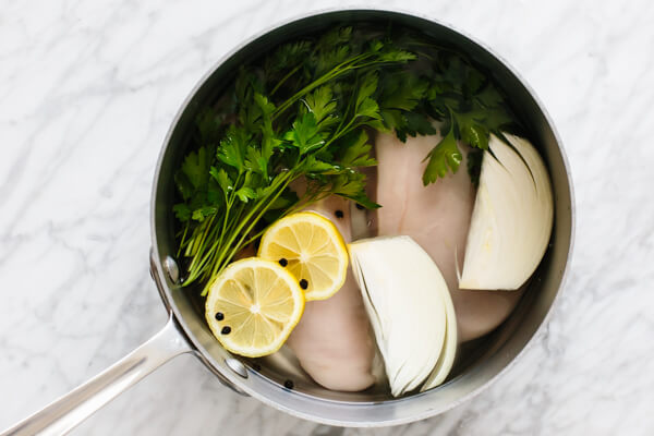 Chicken poaching in a pot.