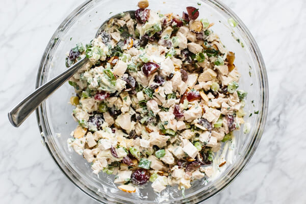 Mixing the ingredients for chicken salad in a bowl.