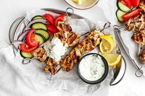 A plate of chicken souvlaki and veggies