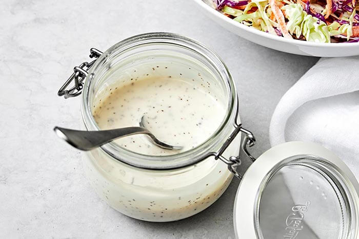 Coleslaw dressing in a container.