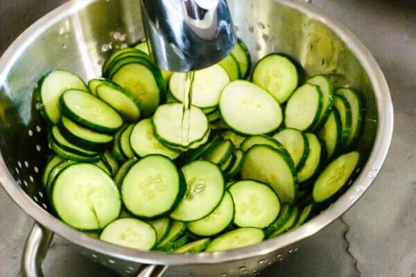 Rinsing cucumbers with water for cucumber salad