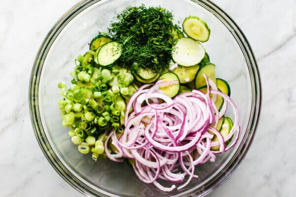 Cucumber salad ingredients in a large bowl