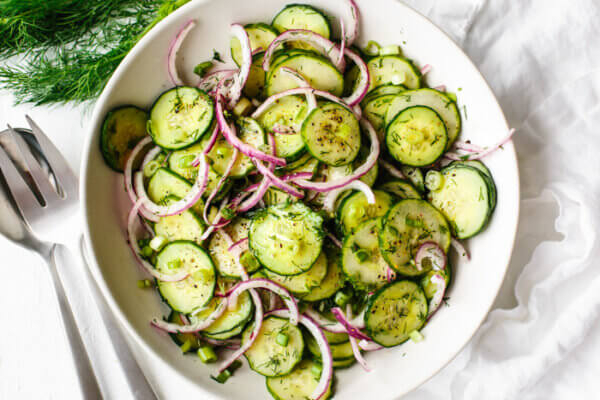 A big white bowl filled with cucumber salad