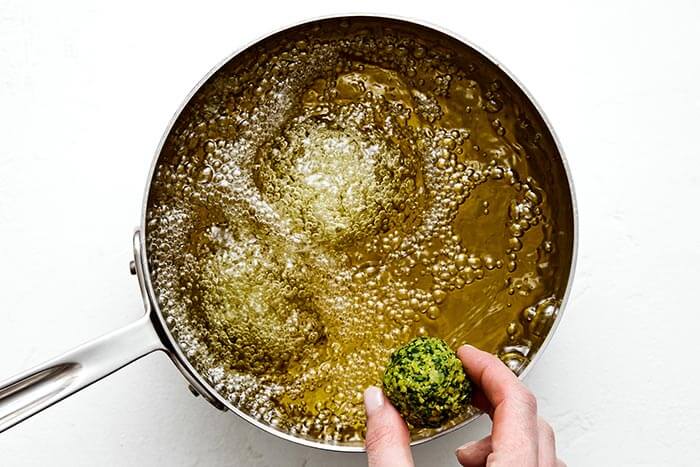 Deep fried falafel ball in a pot.