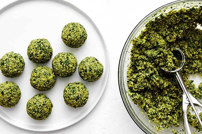 Using a cookie scoop to make falafel balls.