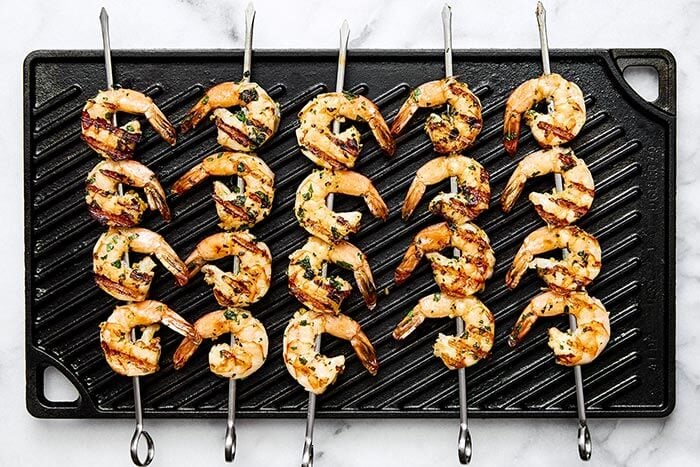 Grilling shrimp skewers on an indoor grill pan.