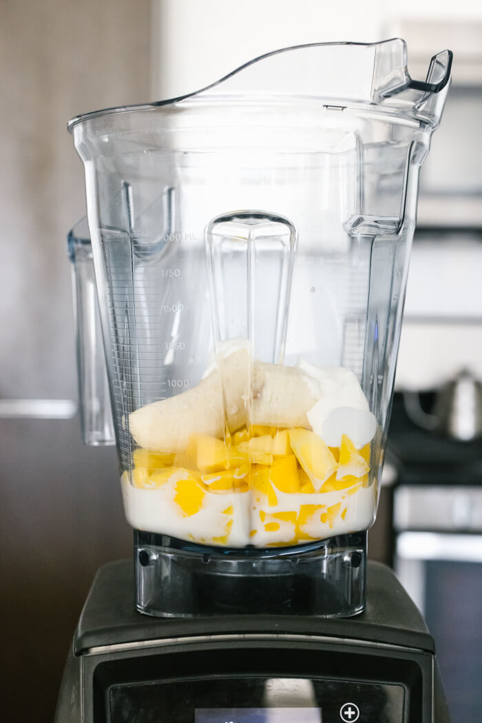 Mango smoothie ingredients in a blender