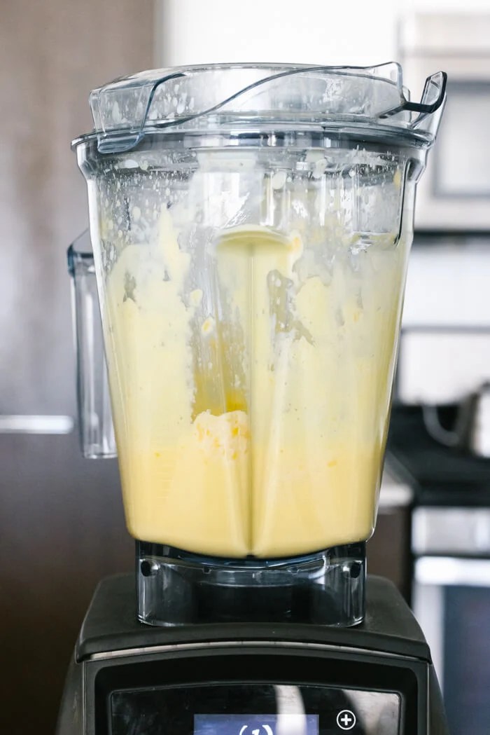 Blended mango smoothie in a blender