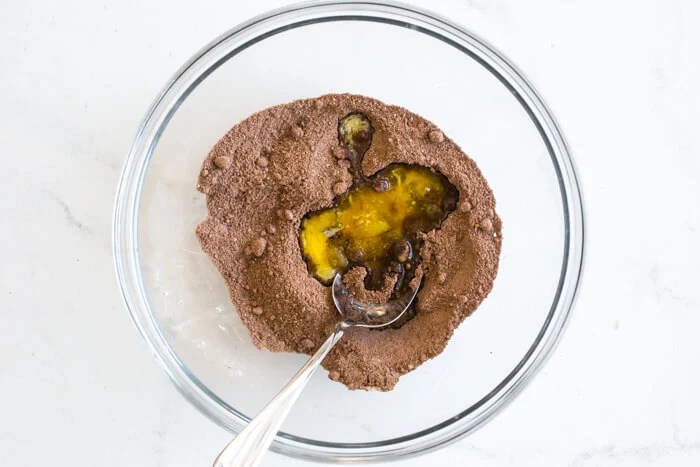 A bowl of dry and wet cookie ingredients.