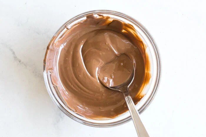 Melted chocolate in a bowl with spoon.