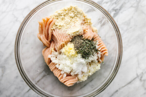 Mixing turkey meatball ingredients in a bowl