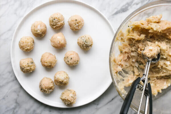 Raw turkey meatballs on a white plate