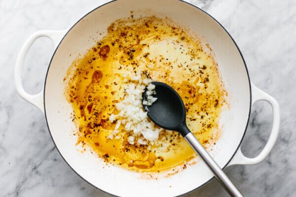 Cooking onions in a skillet for tuscan chicken