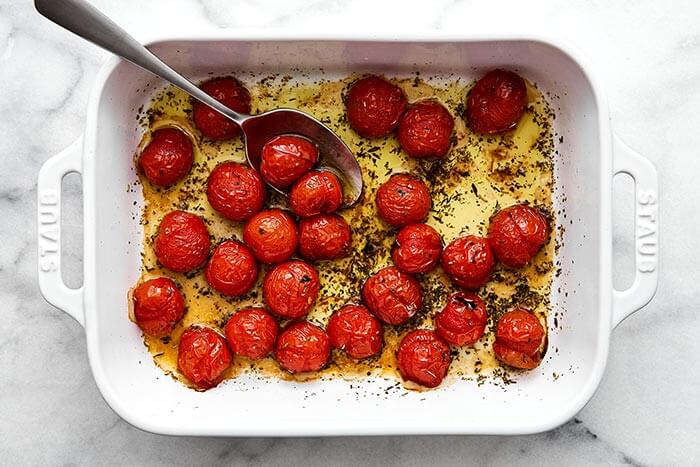 Roasted tomatoes in a baking dish.