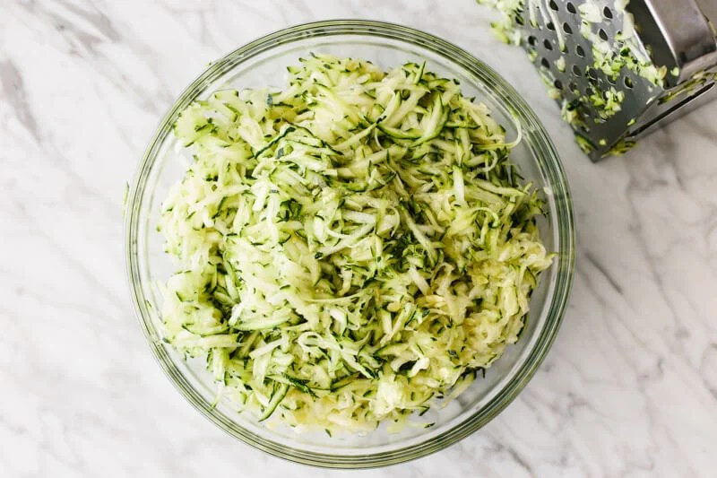 Grated zucchini in a bowl.