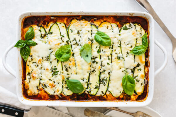 A white baking dish of zucchini lasagna