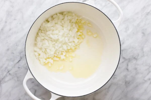 Sauteeing onions in a pot for zucchini soup