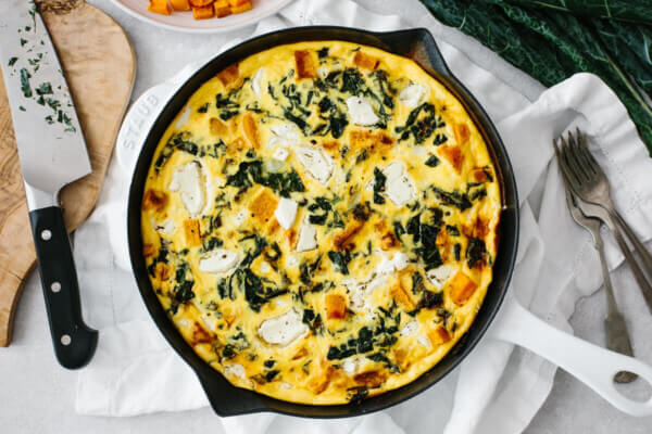 Kale and butternut squash frittata served on a table.